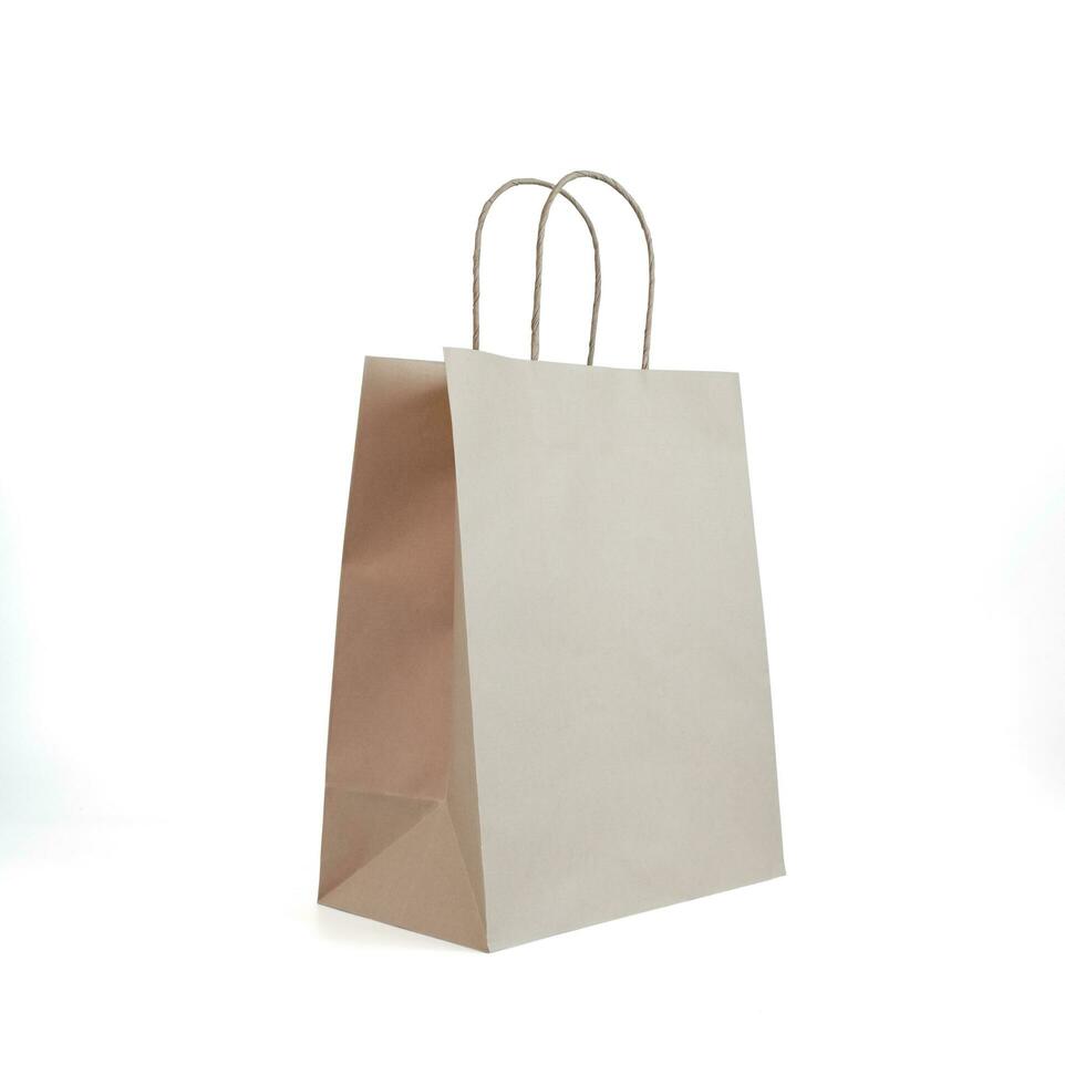 Folded paper bag with handle,  Recycled paper, shopping bag, isolated on white background photo