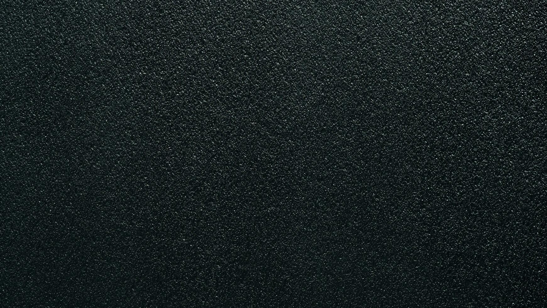 Seamless surface of black sponge foam as background, ethylene vinyl acetate sheet, sandpaper-like fine texture. photo