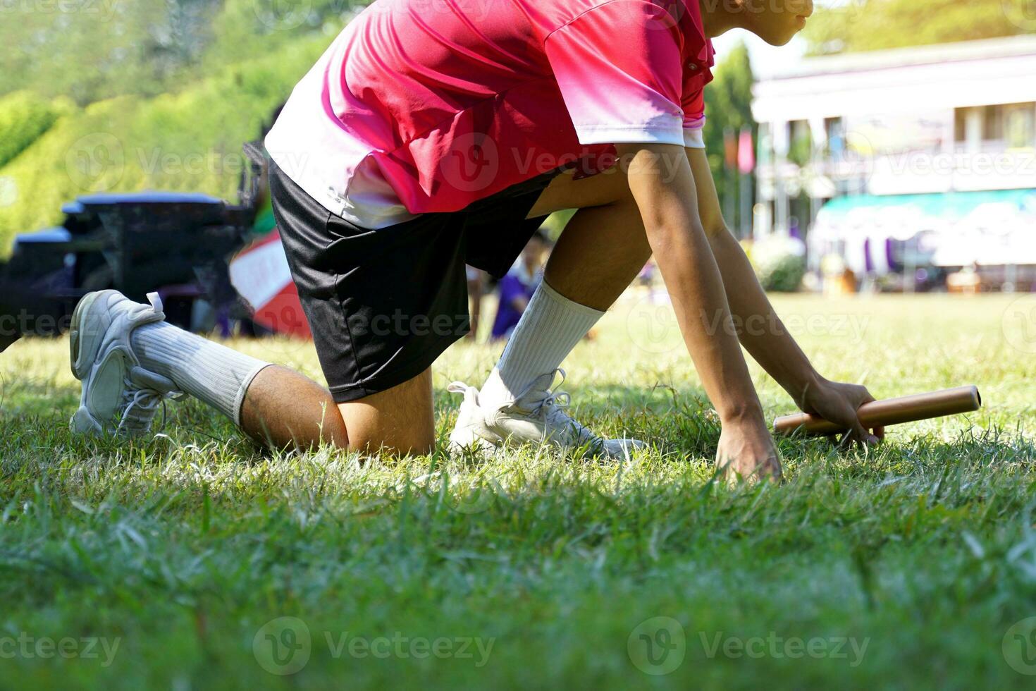 Runners wearing pink shirts are ready to start at the starting point. Soft and selective focus. photo