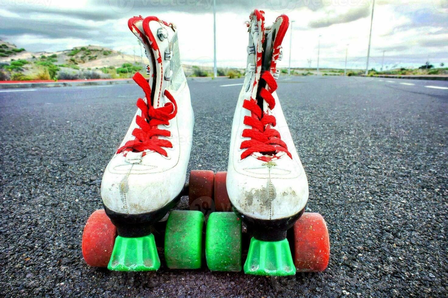 a pair of roller skates on the ground photo