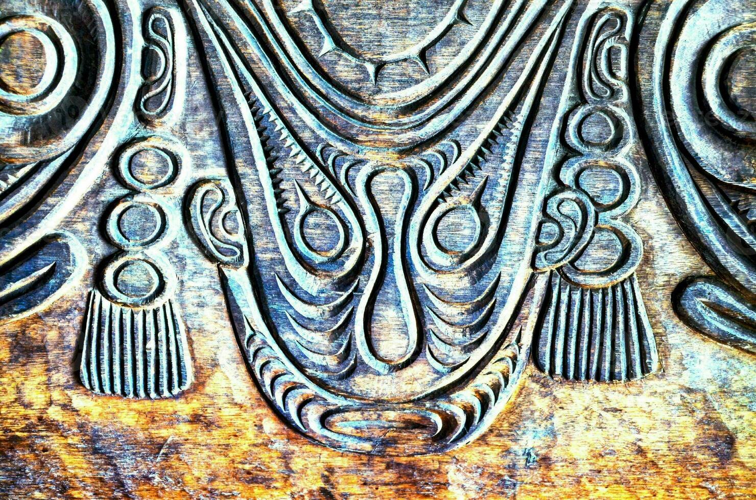 a close up of a carved wooden panel photo