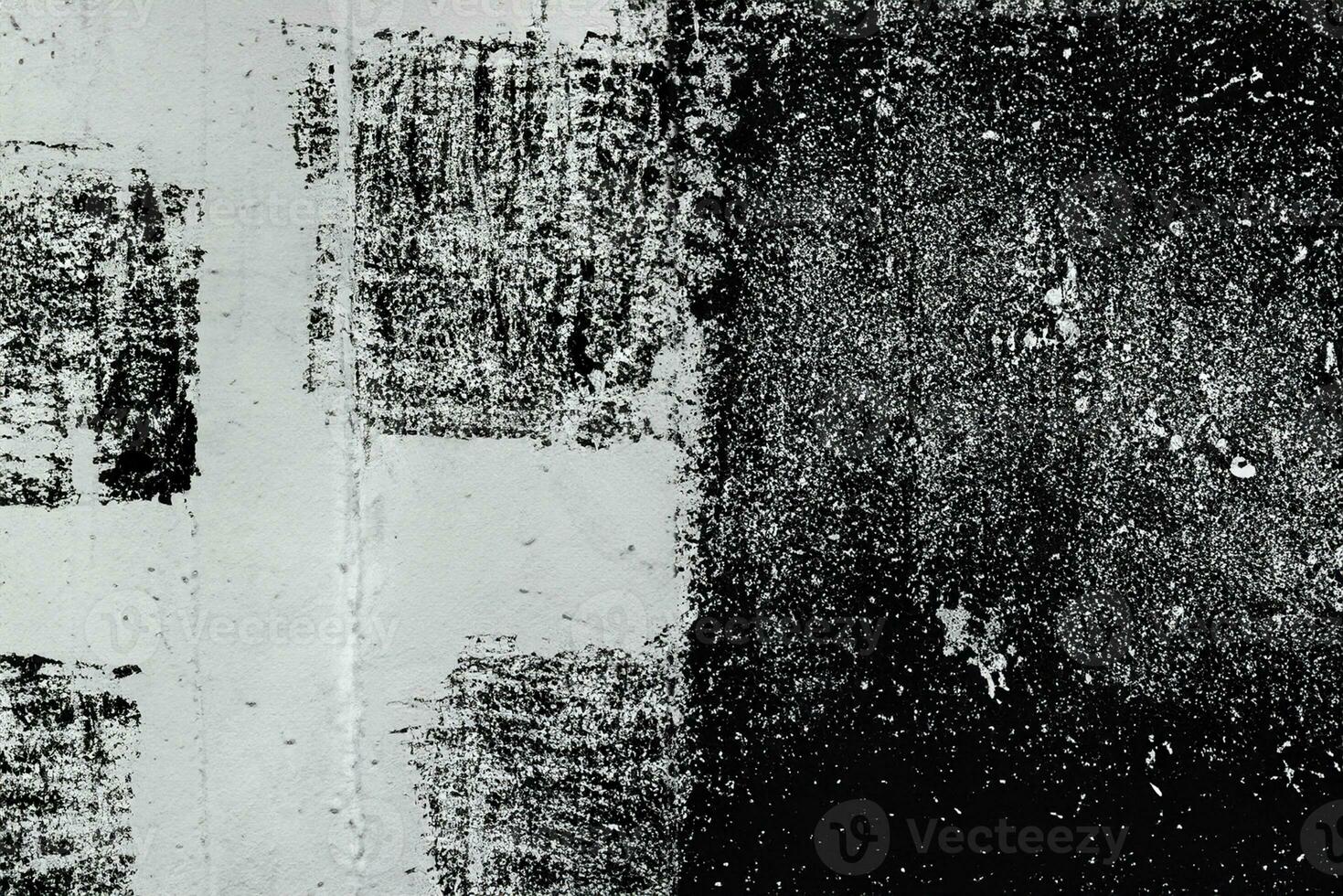 Abstract grunge texture pattern of black paint on white wall photo