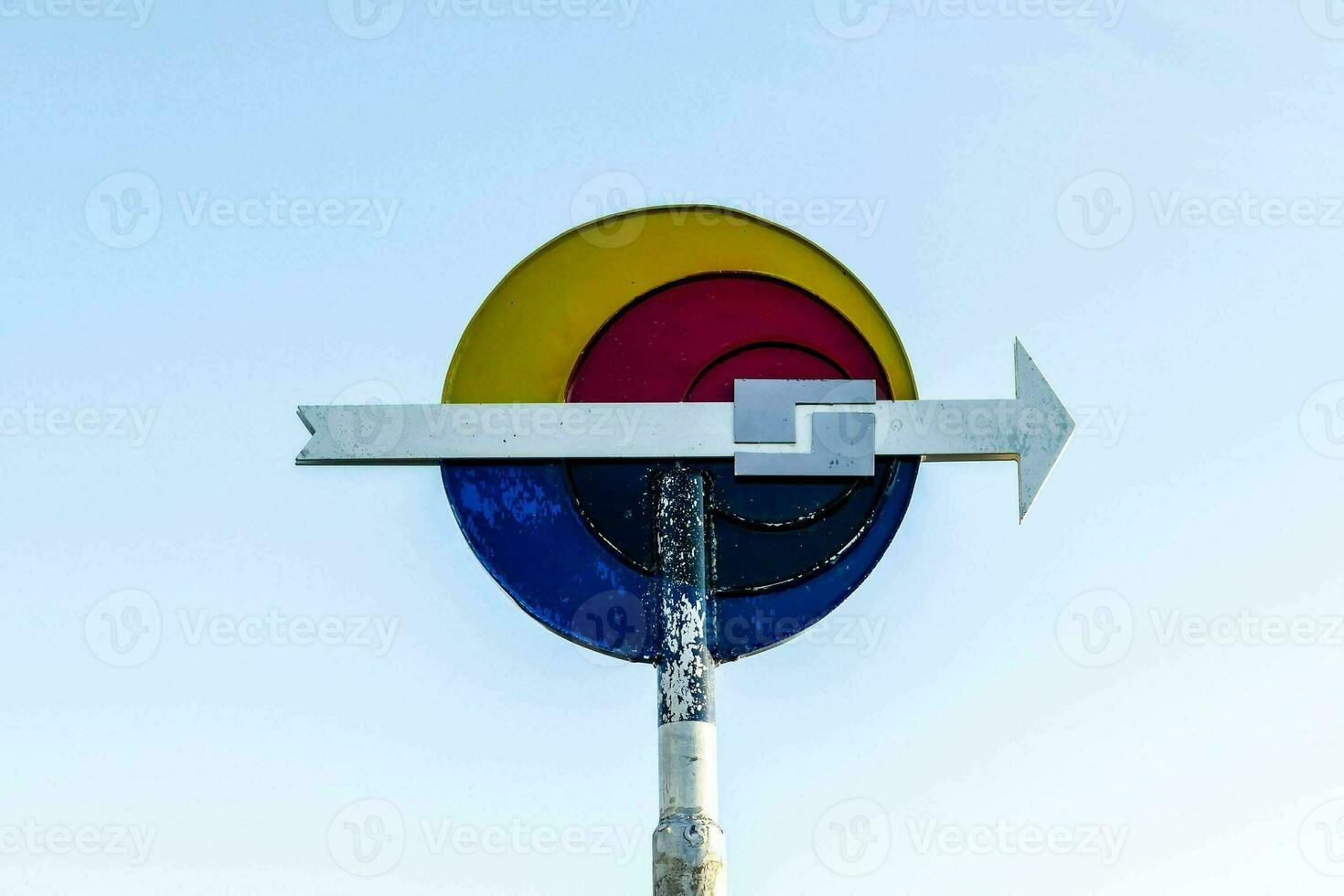 a colorful sign with an arrow pointing to the right photo