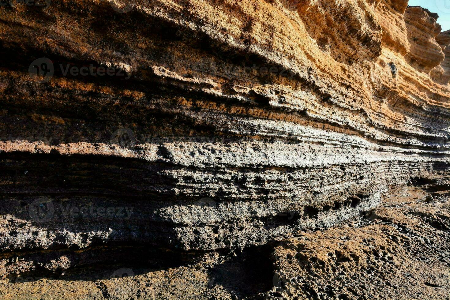 a large rock formation with many layers of dirt photo