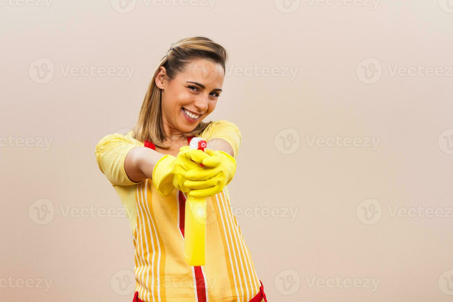 Portrait of happy housewife having fun while cleaning photo