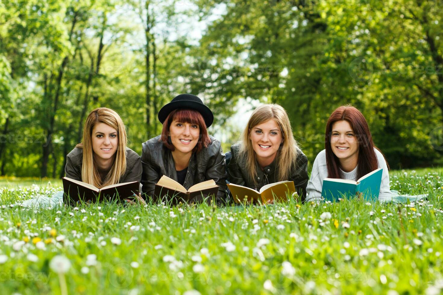 Happy students learning in the park photo