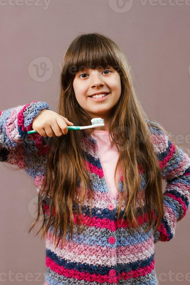 Little girl brushing teeth photo