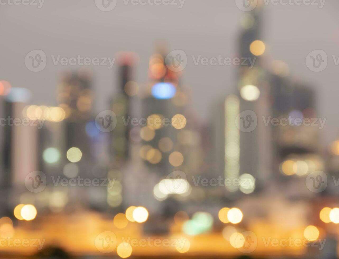 Blurred sunset bokeh lights city office building, abstract background photo