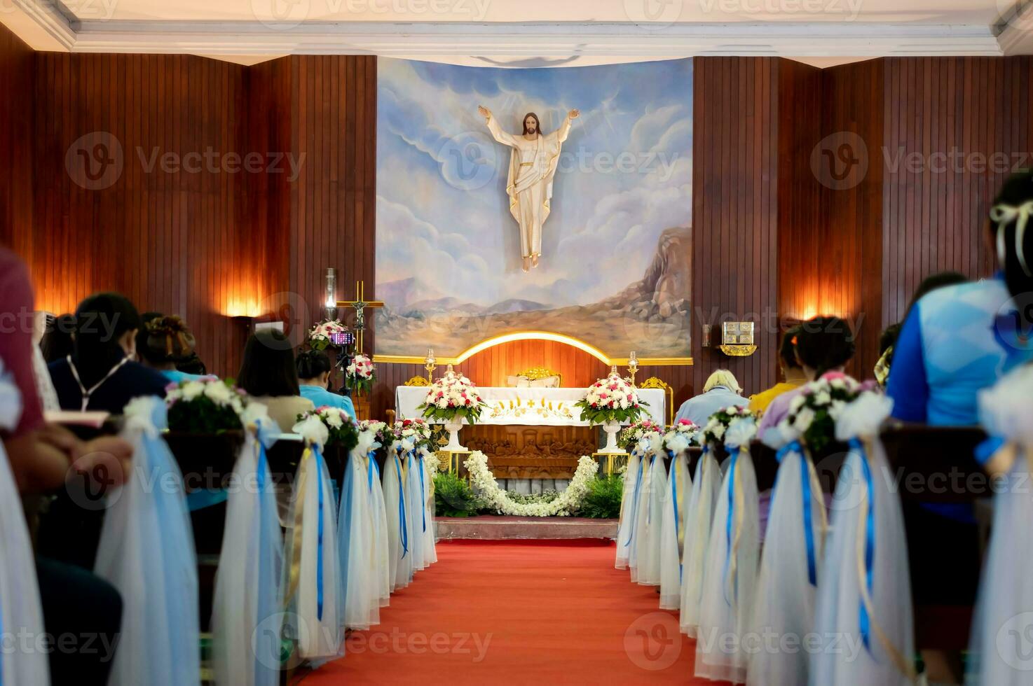 Inside large Christian church, picture of Jesus on the wall, and many people were attending religious ceremonies, a Sacred Christian Ceremony. Holy Communion, Divine Mass ,Guidance of the Bible photo