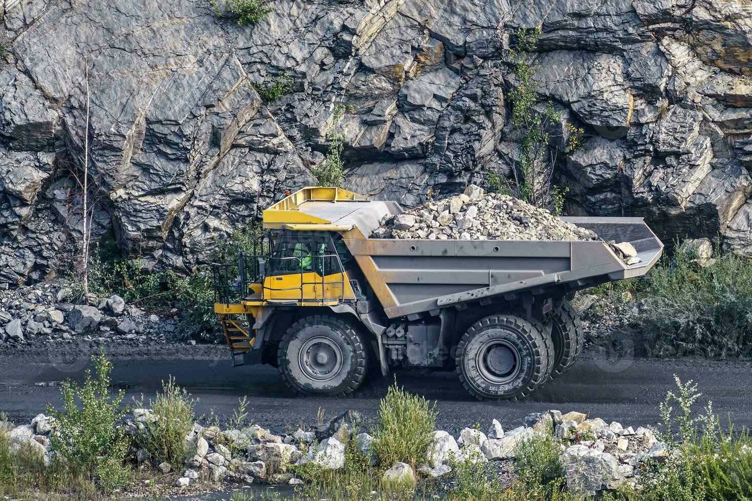 Dump truck in limestone mining, heavy machinery. Mining in the quarry. photo