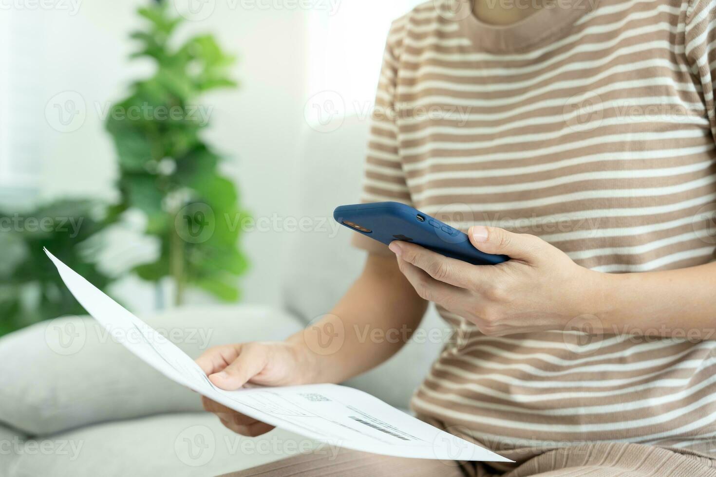 Modern woman use phone to scan barcode or QR codes to pay credit card bill after receive document invoice. payment, receive, paying electricity, digital payments without money, technology, scanning photo