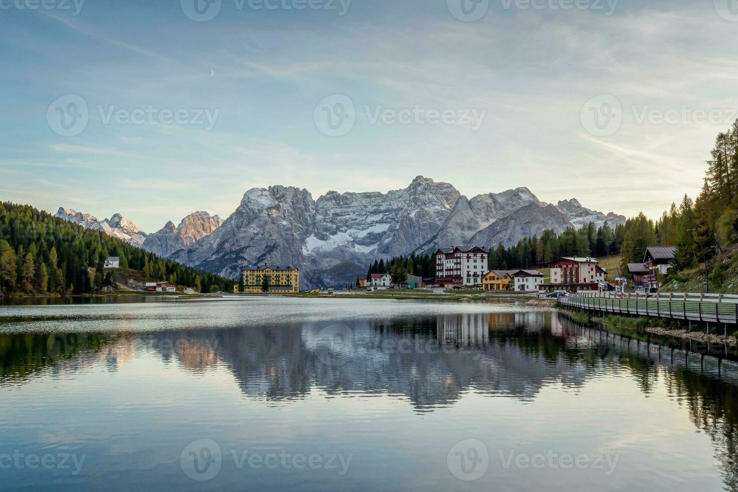 Sunset over Misurina Lake with sky reflection in calm water. View on the majestic Dolomites Alp Mountains, National Park Tre Cime di Lavaredo, Dolomiti Alps, South Tyrol, Italy photo