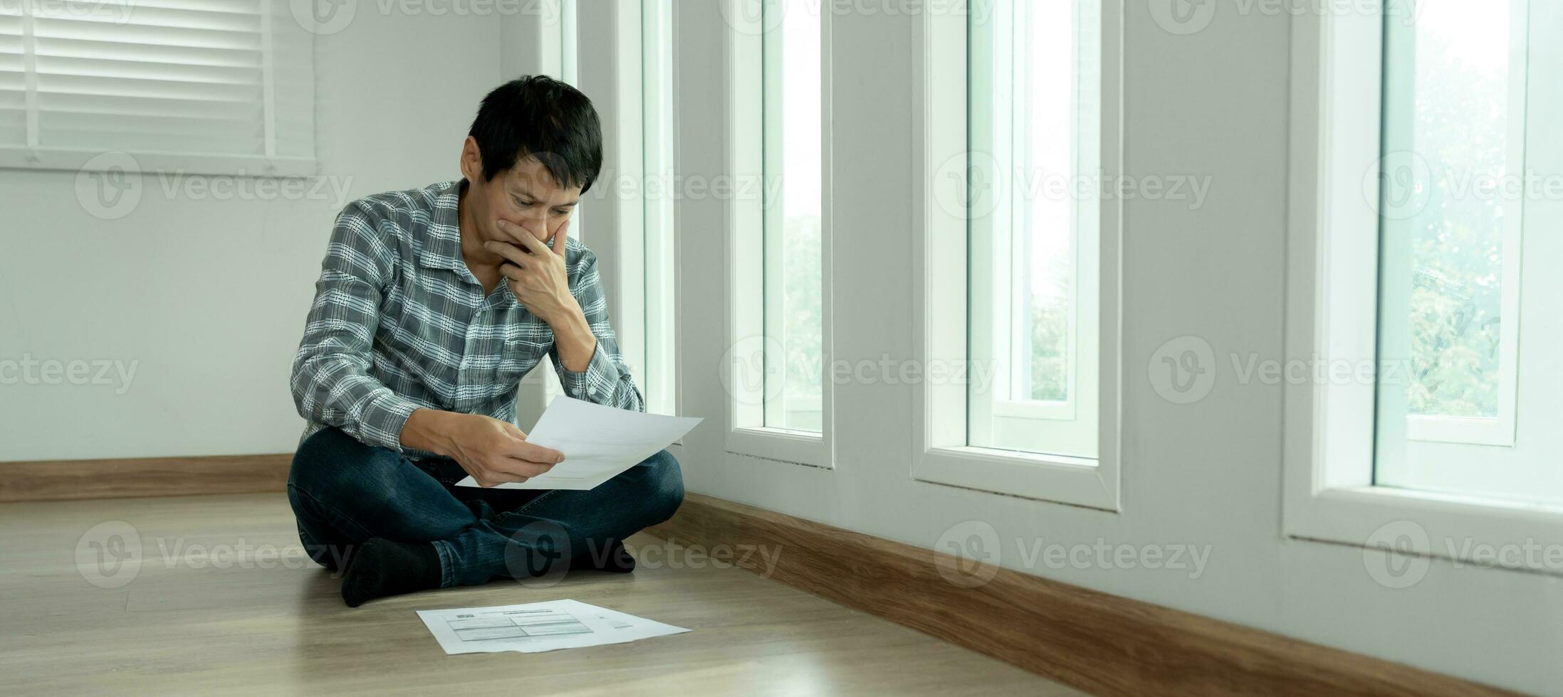 Stressed and headache asian man with large bills or invoices no money to pay to expenses and credit card debt. shortage, Financial problems, mortgage, loan, bankruptcy, bankrupt, poor, empty wallet photo