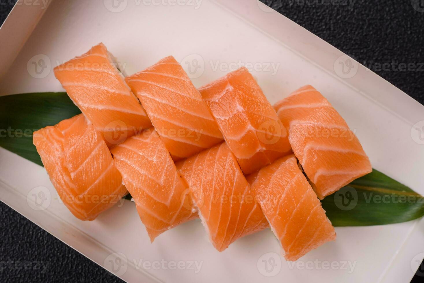 Delicious Philadelphia sushi roll with salmon, shrimp, cucumber and cream cheese photo