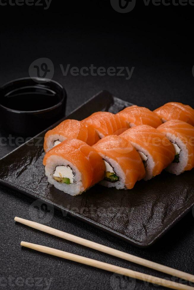 Delicious Philadelphia sushi roll with salmon, shrimp, cucumber and cream cheese photo