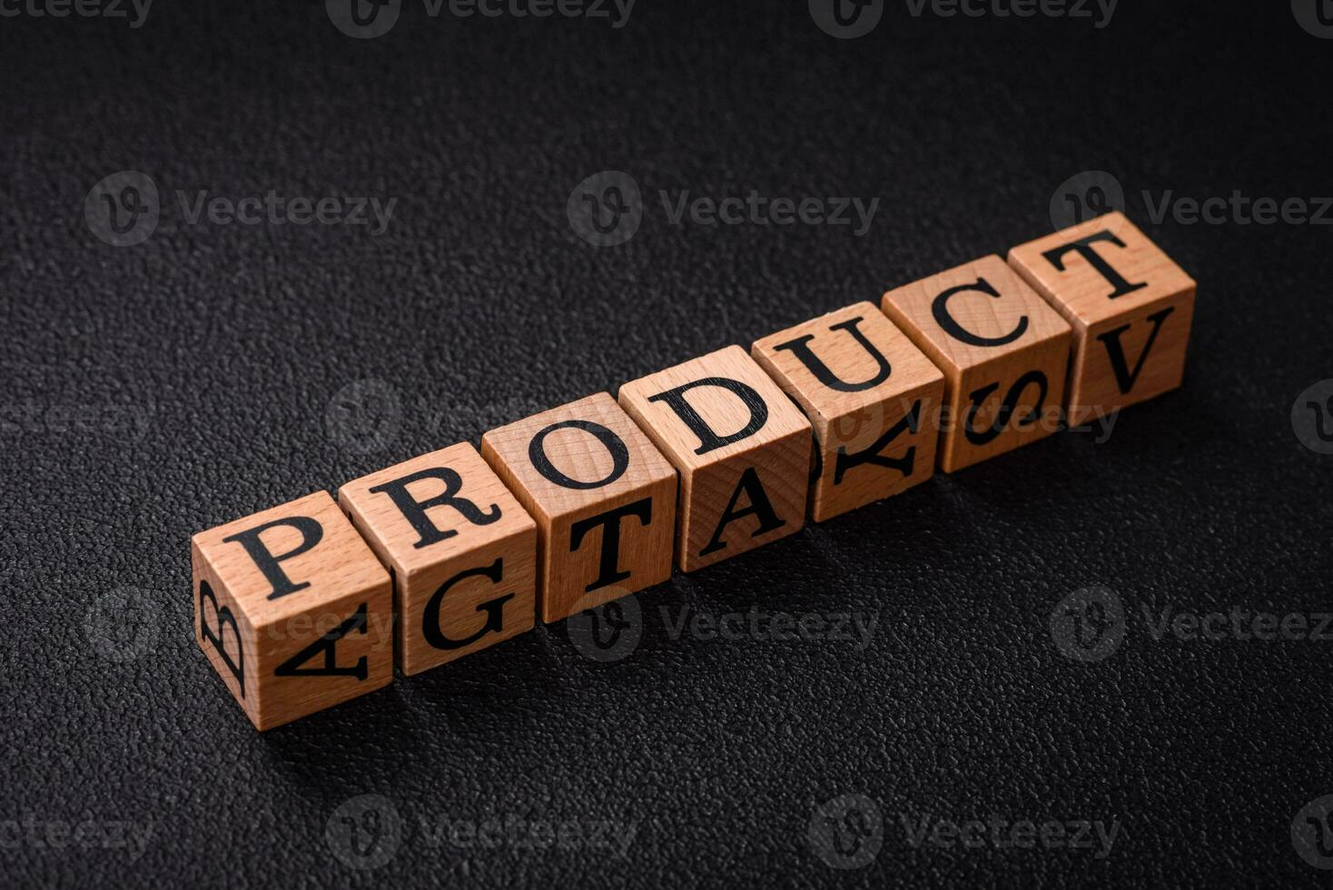 The inscription product with wooden cubes on a dark concrete background photo