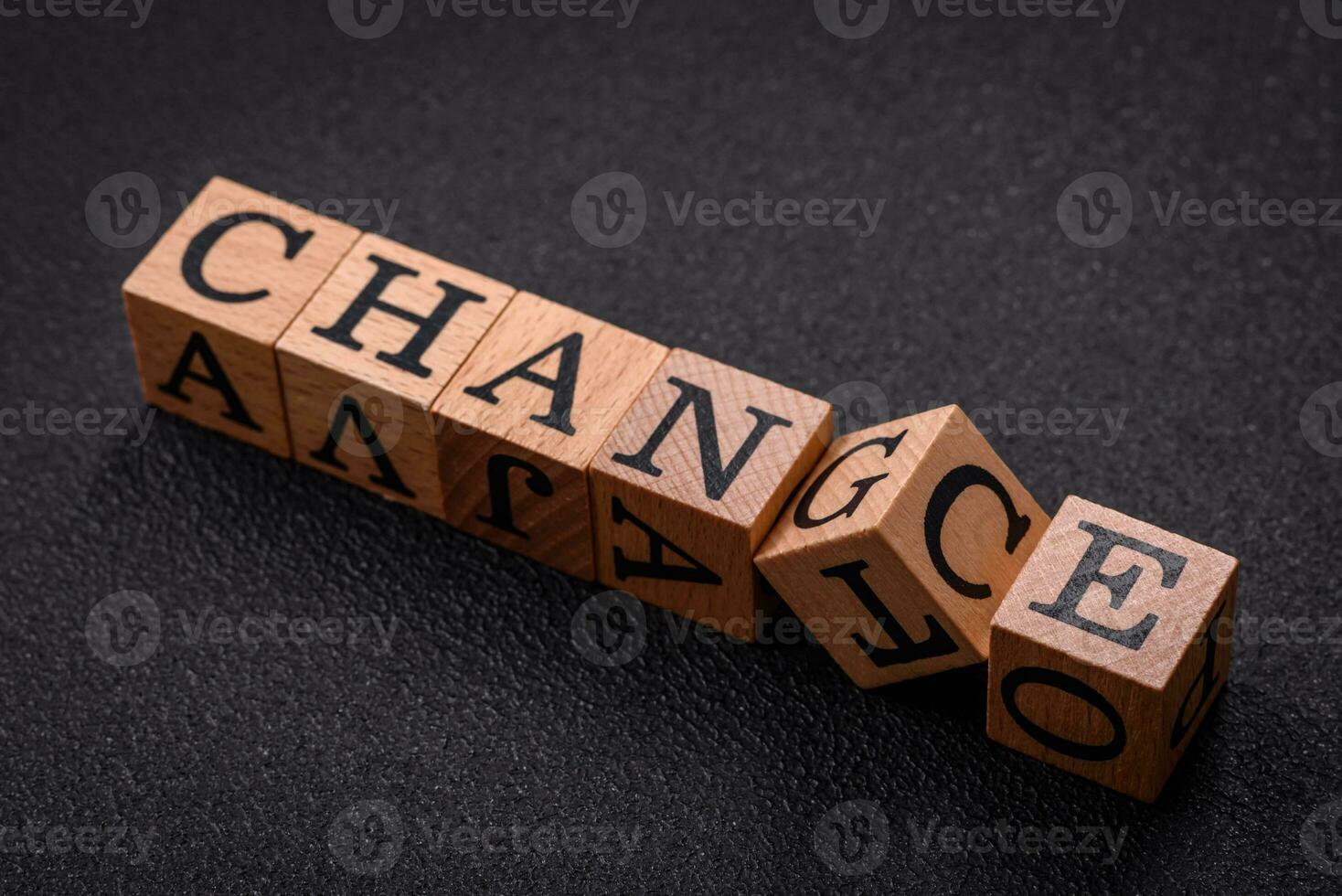 The inscription chance or change with wooden cubes on a dark concrete background photo