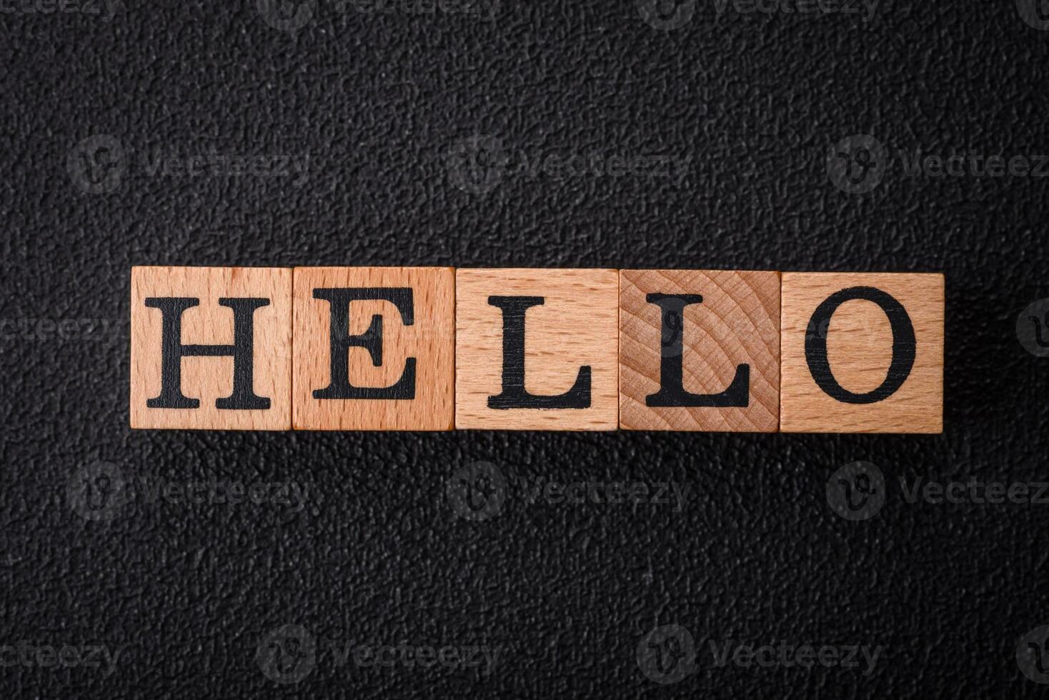 The inscription hello on wooden cubes on a dark concrete background photo