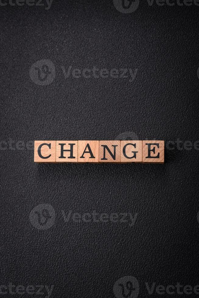 The inscription chance or change with wooden cubes on a dark concrete background photo