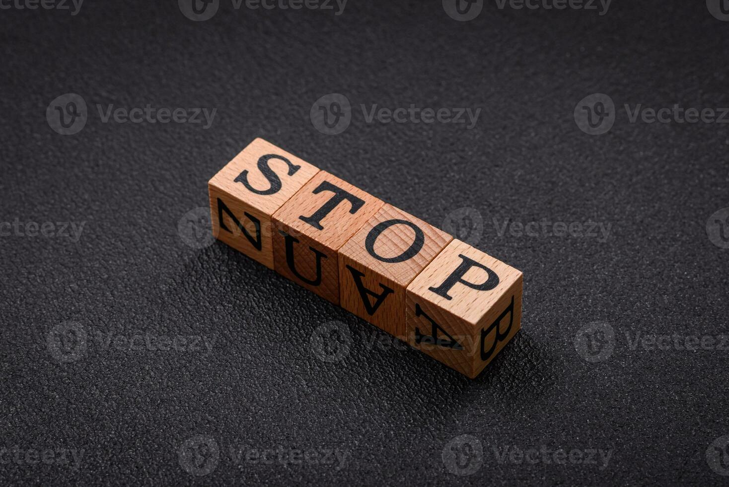 The inscription stop on wooden cubes on a dark concrete background photo