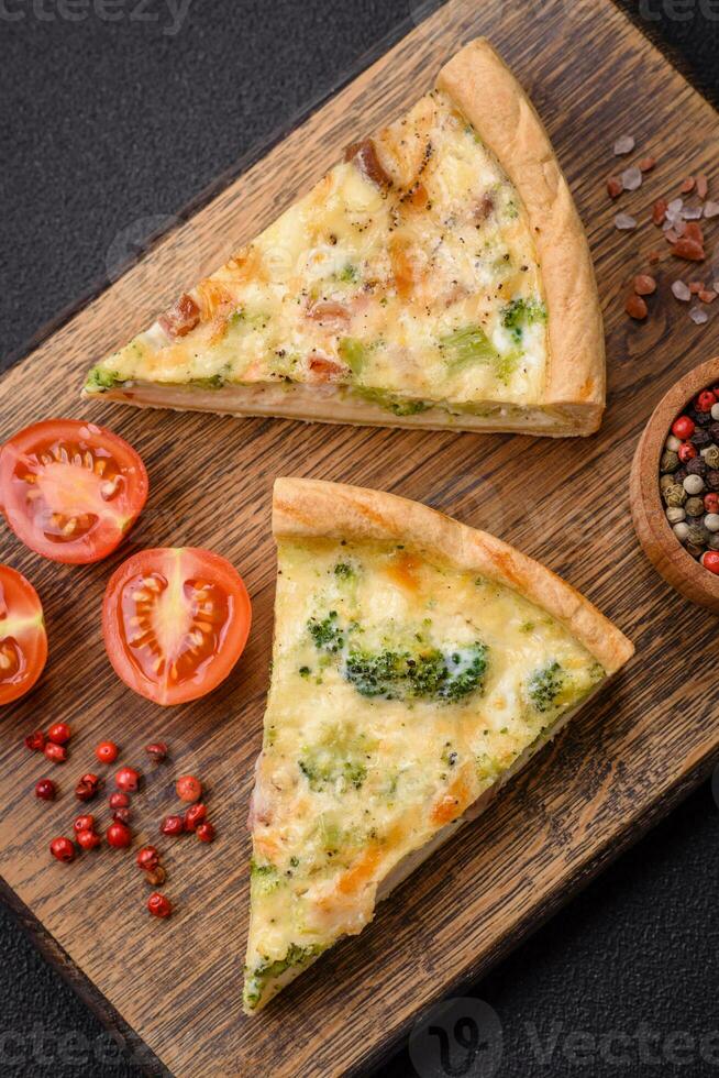 Delicious quiche with broccoli, cheese, chicken, spices and herbs photo