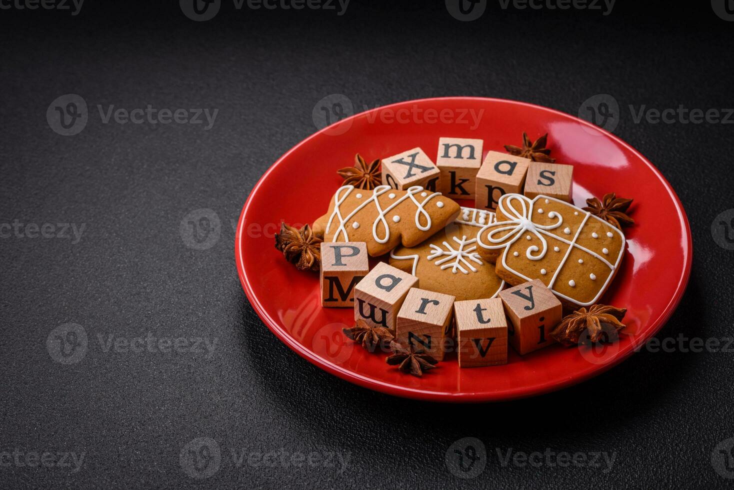 Christmas party inscription with wooden cubes on a dark concrete background photo