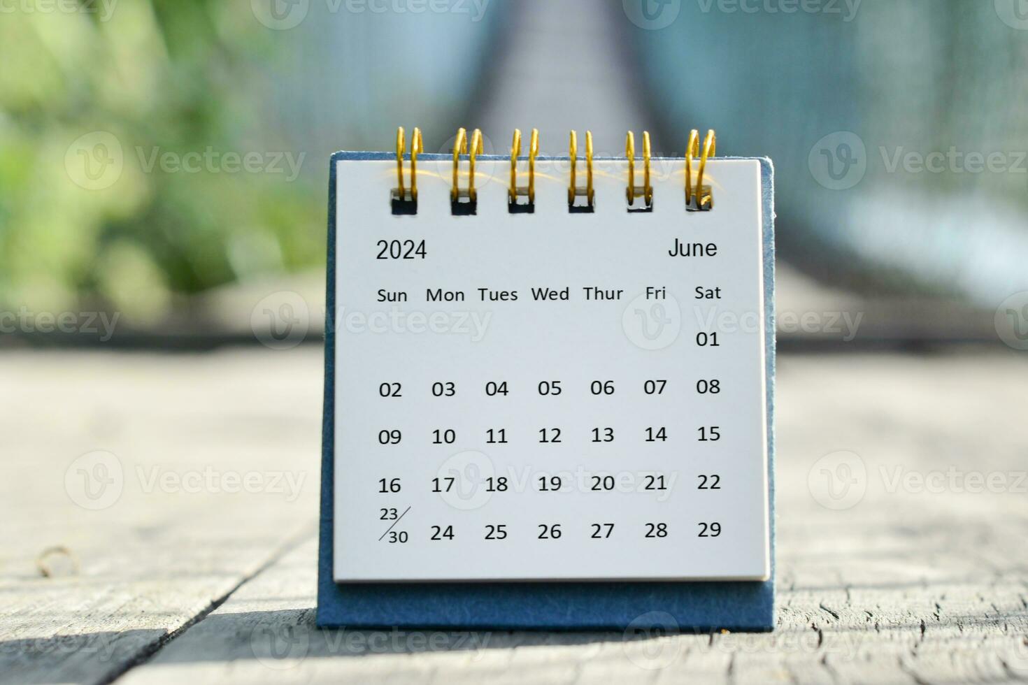 June 2024 white calendar with green blurred background. New year concept. photo