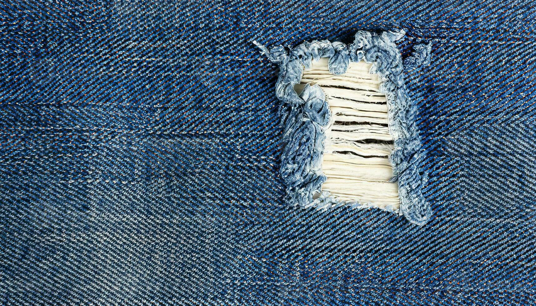 AI generated Blue jeans with a white stripe that has been torn off, Destroyed torn denim blue jeans texture, close-up rip in blue denim fabric, revealing white fabric underneath photo