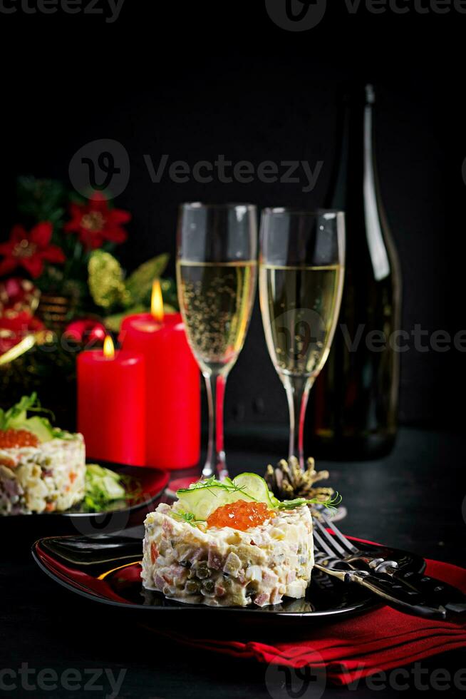 Christmas table setting. Traditional Russian salad Olivier. New Year salad. Festive salad. photo