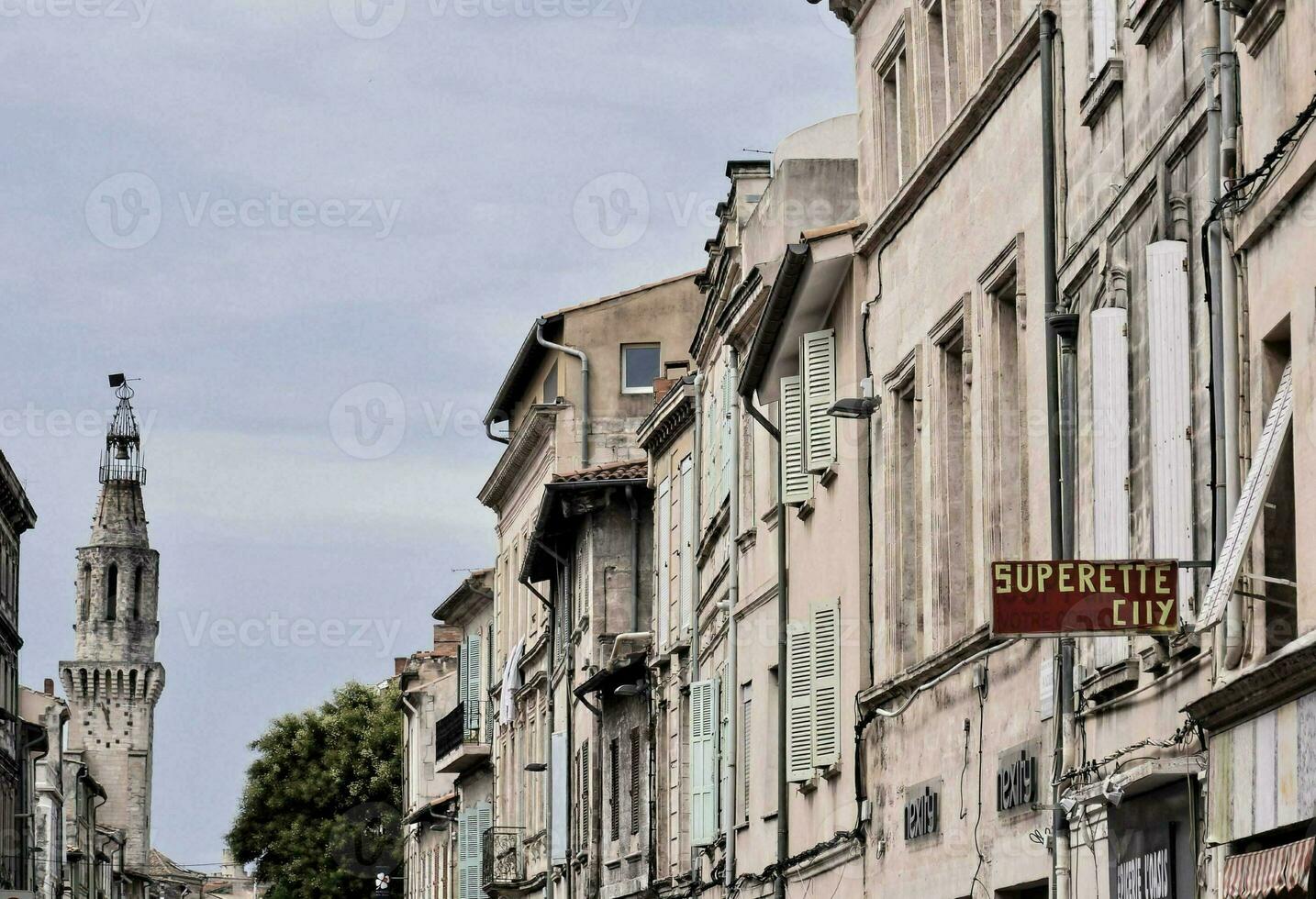 a street with buildings and a tower in the background photo