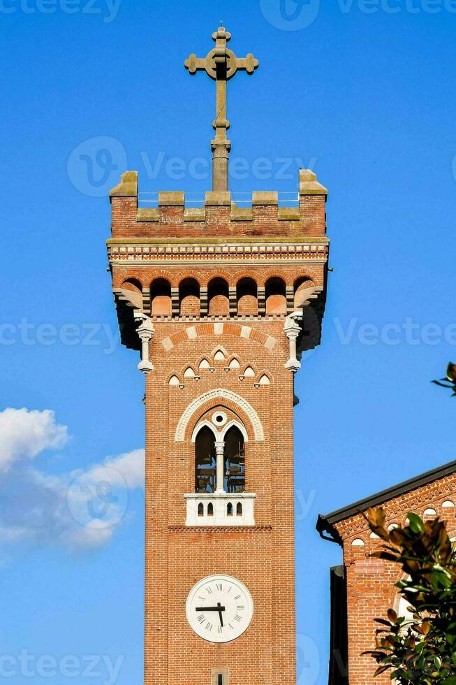 a clock tower with a cross on top photo