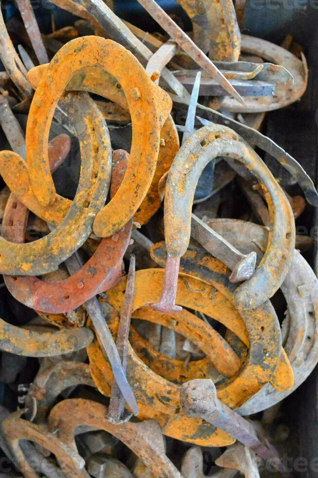 a pile of old rusty horseshoes photo