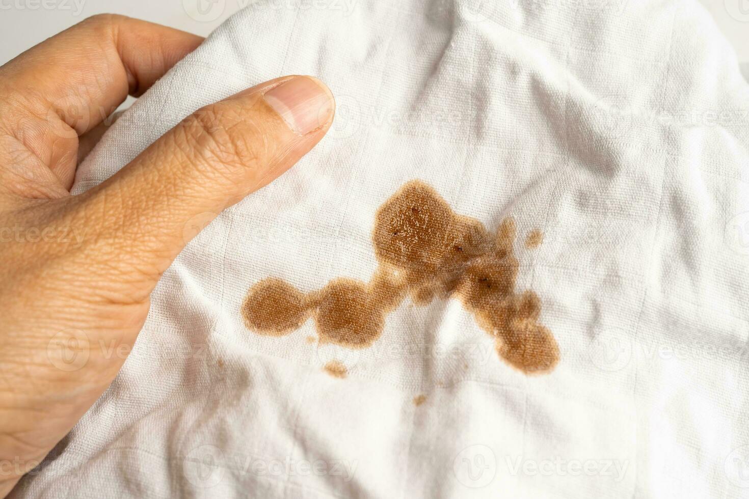 Dirty tomato sauce stain or ketchup on cloth to wash with washing powder, cleaning housework concept. photo