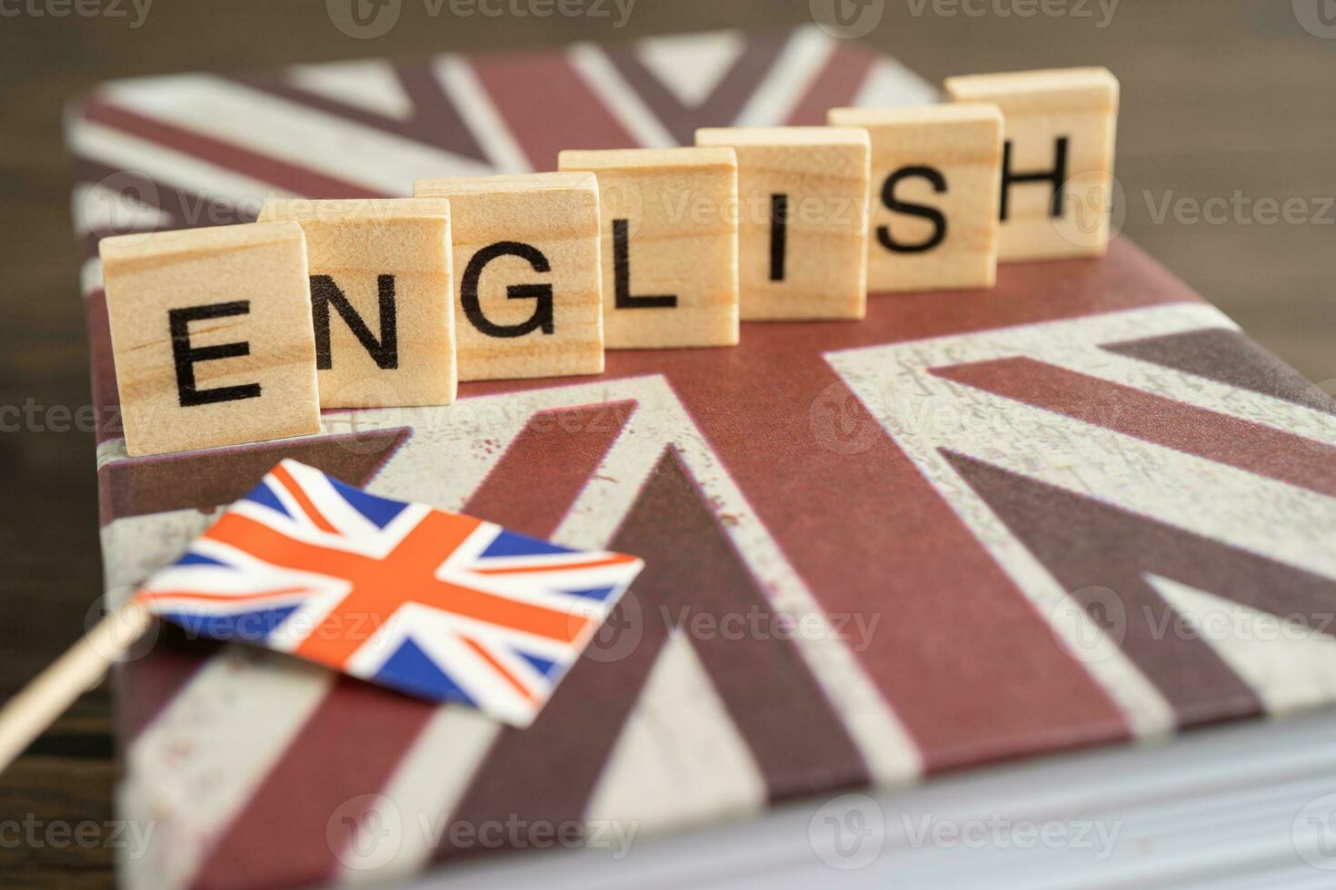 Word English on book with United Kingdom flag, learning English language courses concept. photo