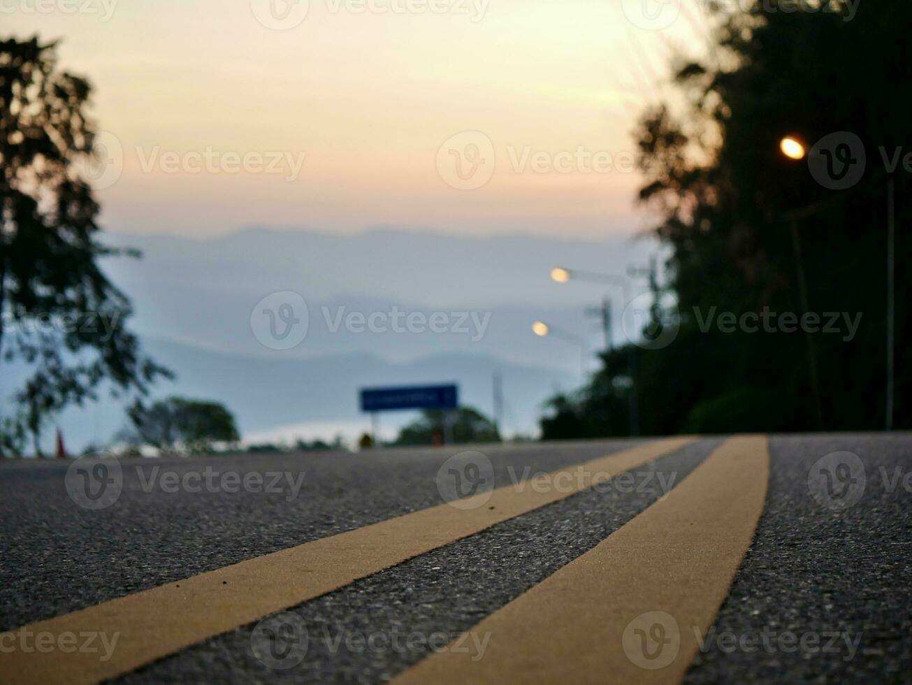 Yellow traffic line color Double solid lines to warn prohibiting overtaking, Yellow continuous tracks of prohibited overtaking painted on the asphalt, Safety driving and traffic regulating rules photo