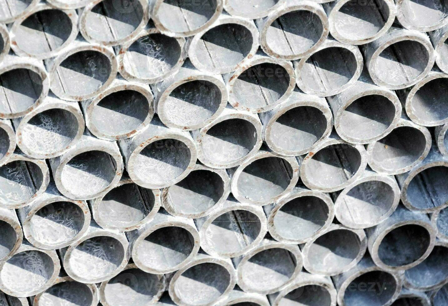 a close up of a pile of metal pipes photo