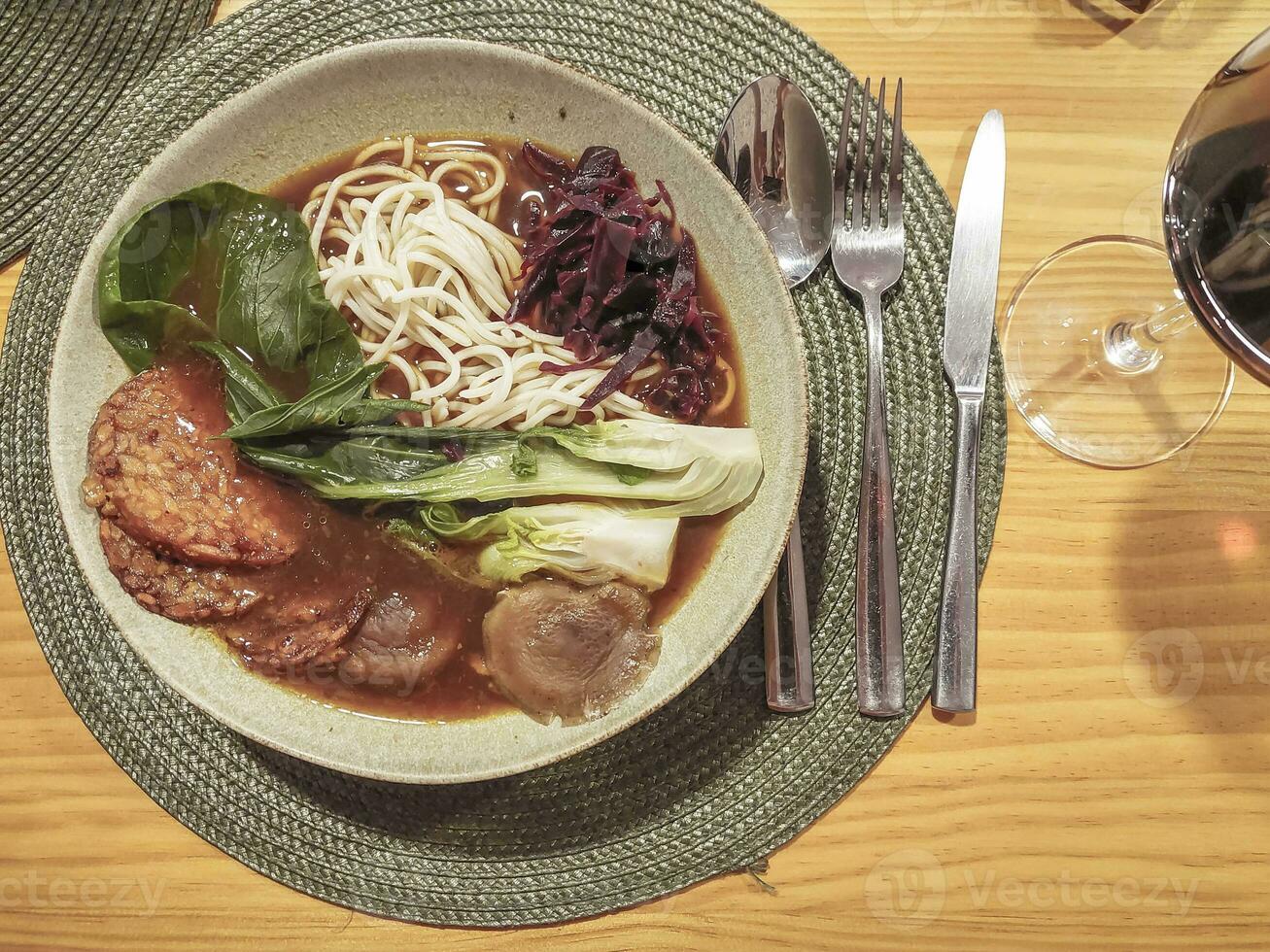 Vegan Asian noodle soup with Tempeh cabbage and mushrooms. photo