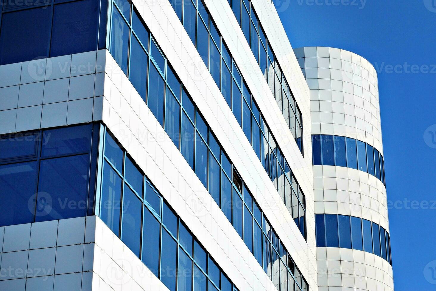Modern office building in the city with windows and  steel and aluminum panels wall. Contemporary commercial architecture, vertical converging geometric lines. photo