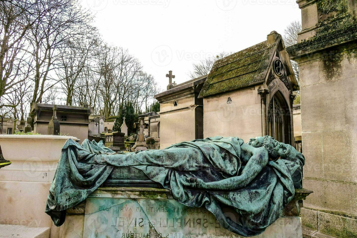 a statue of a woman lying on a tombstone photo