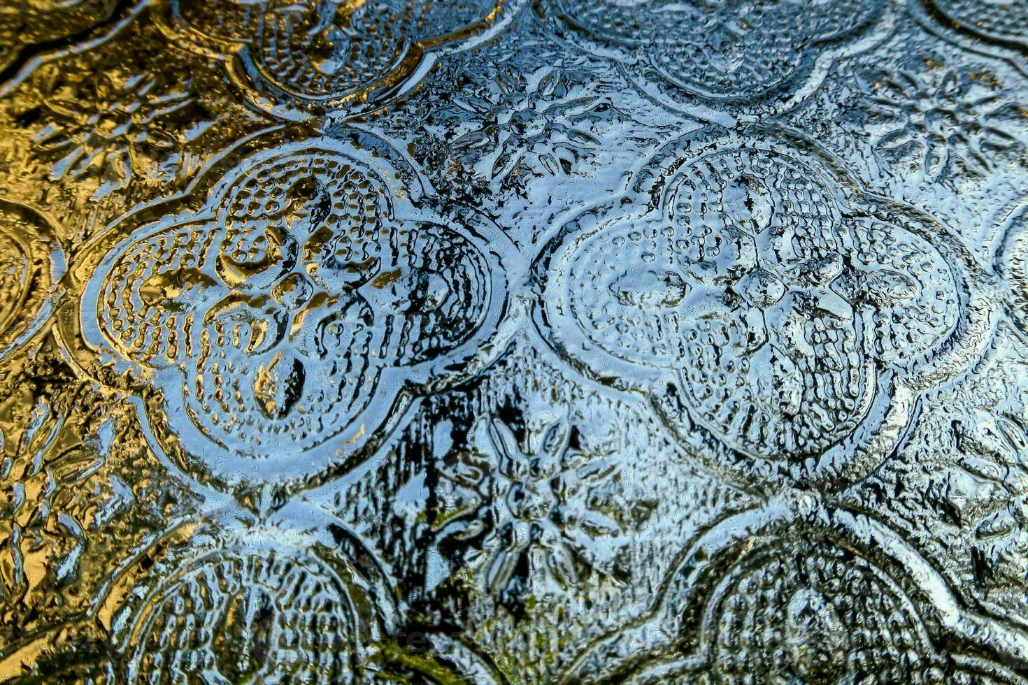 a close up of a glass window with a pattern photo