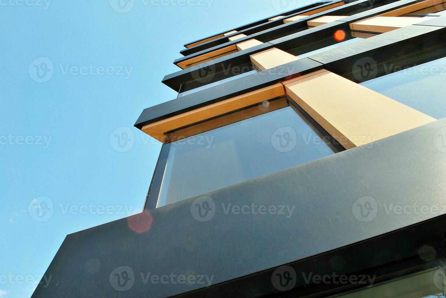 Glass building with transparent facade of the building and blue sky. Structural glass wall reflecting blue sky. Abstract modern architecture fragment. Contemporary architectural background. photo