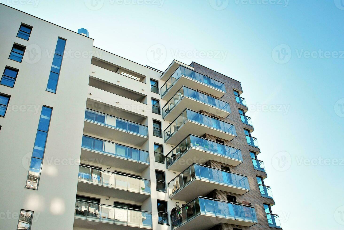 Modern apartment building in sunny day. Exterior, residential house facade. photo