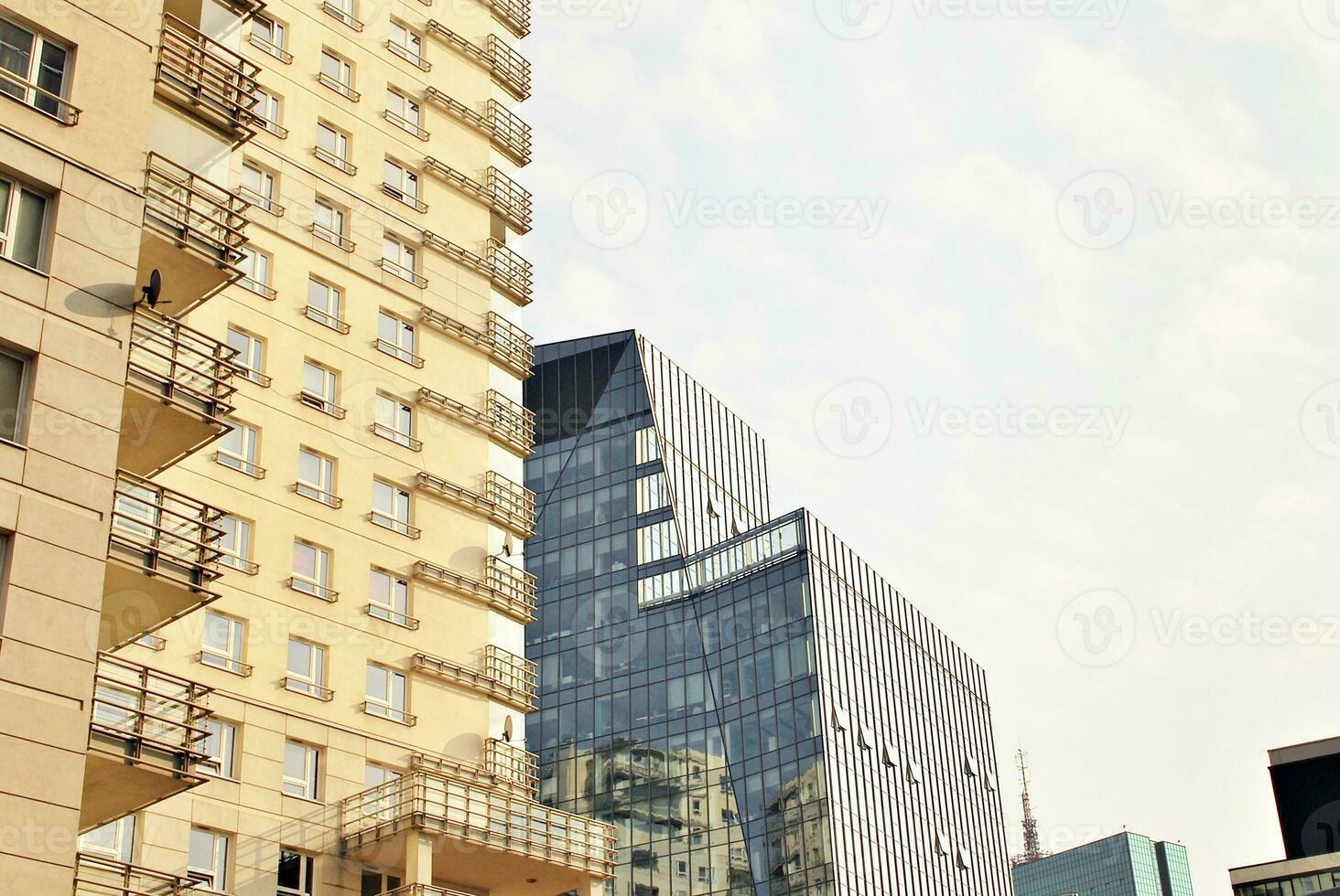 New apartment building with glass balconies. Modern architecture houses by the sea. Large glazing on the facade of the building. photo