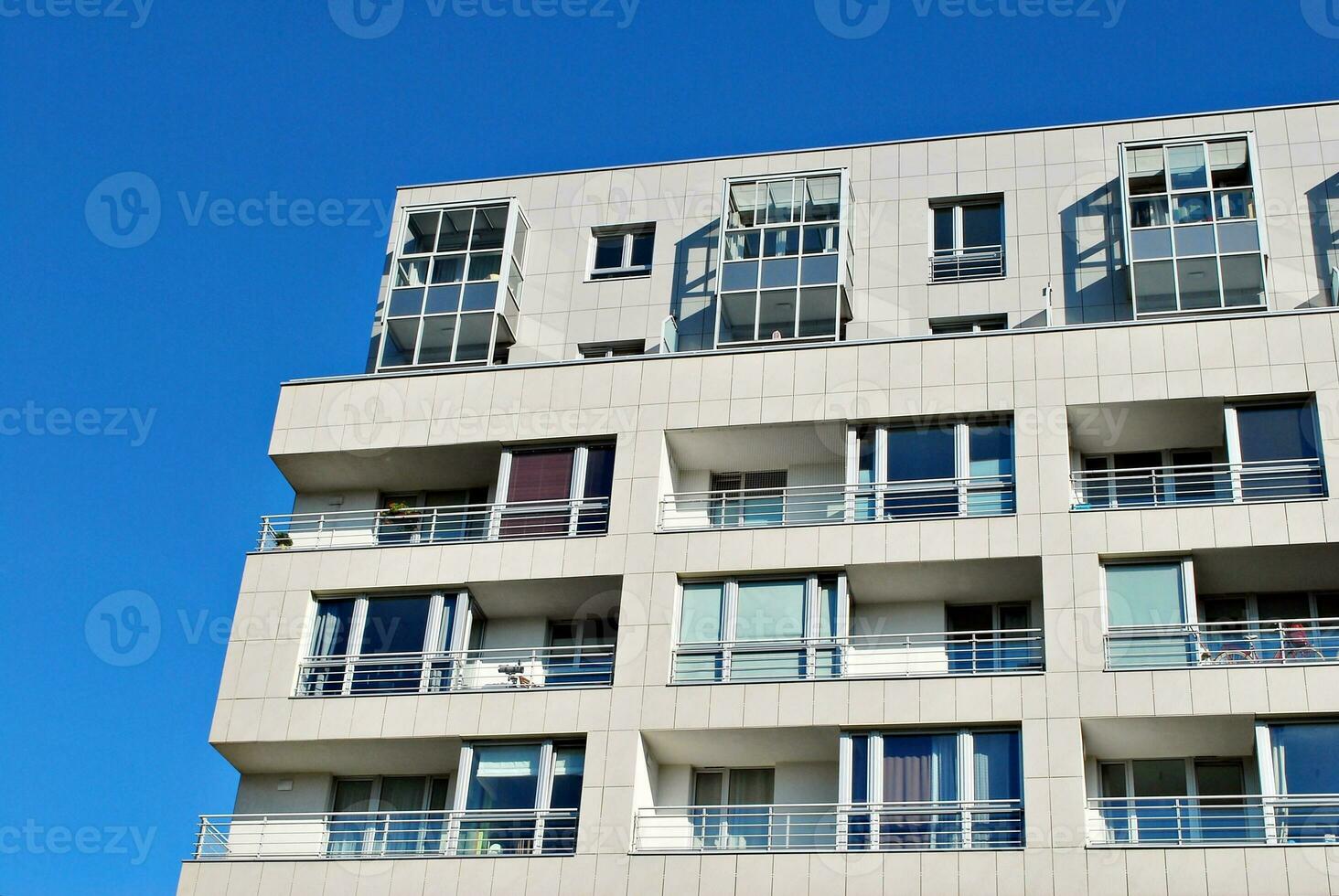 New apartment building with glass balconies. Modern architecture houses by the sea. Large glazing on the facade of the building. photo