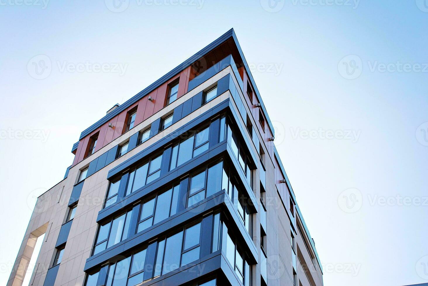 New apartment building with glass balconies. Modern architecture houses by the sea. Large glazing on the facade of the building. photo