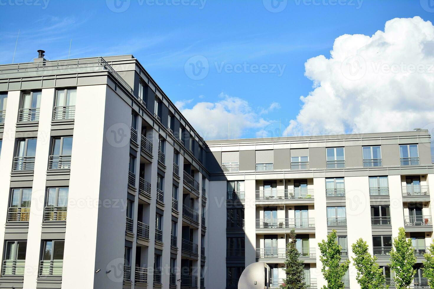 Brand new apartment building on sunny day. Modern residential architecture. Modern multi-family apartment house. photo