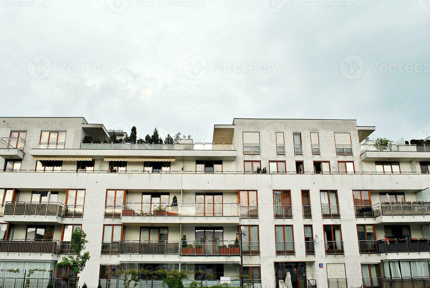 Brand new apartment building on sunny day. Modern residential architecture. Modern multi-family apartment house. photo