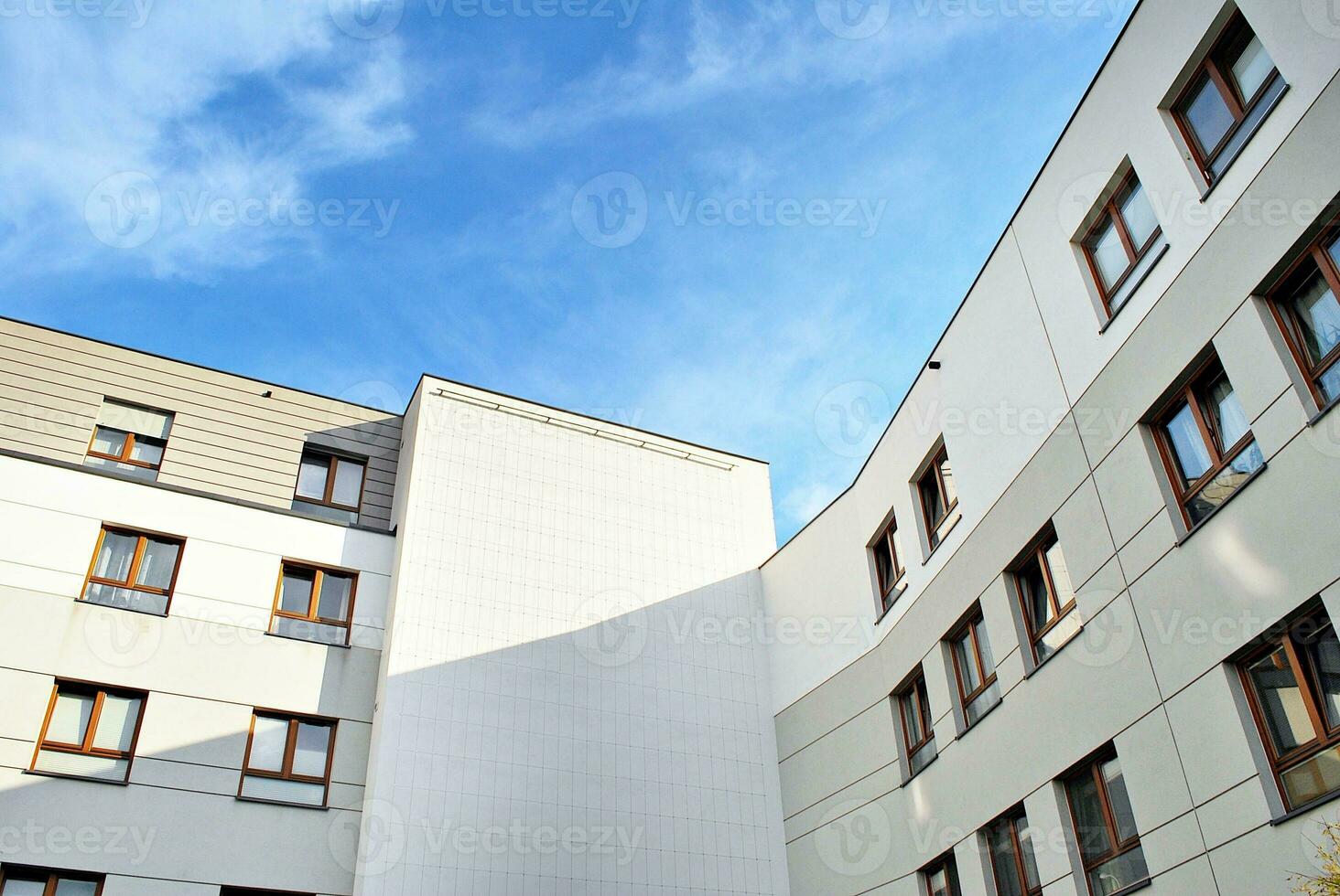 Brand new apartment building on sunny day. Modern residential architecture. Modern multi-family apartment house. photo