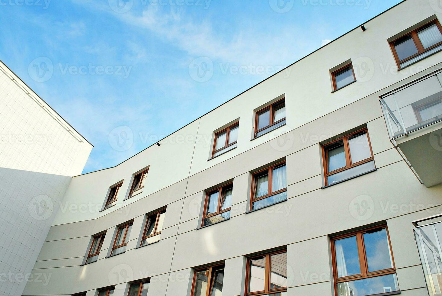 Brand new apartment building on sunny day. Modern residential architecture. Modern multi-family apartment house. photo
