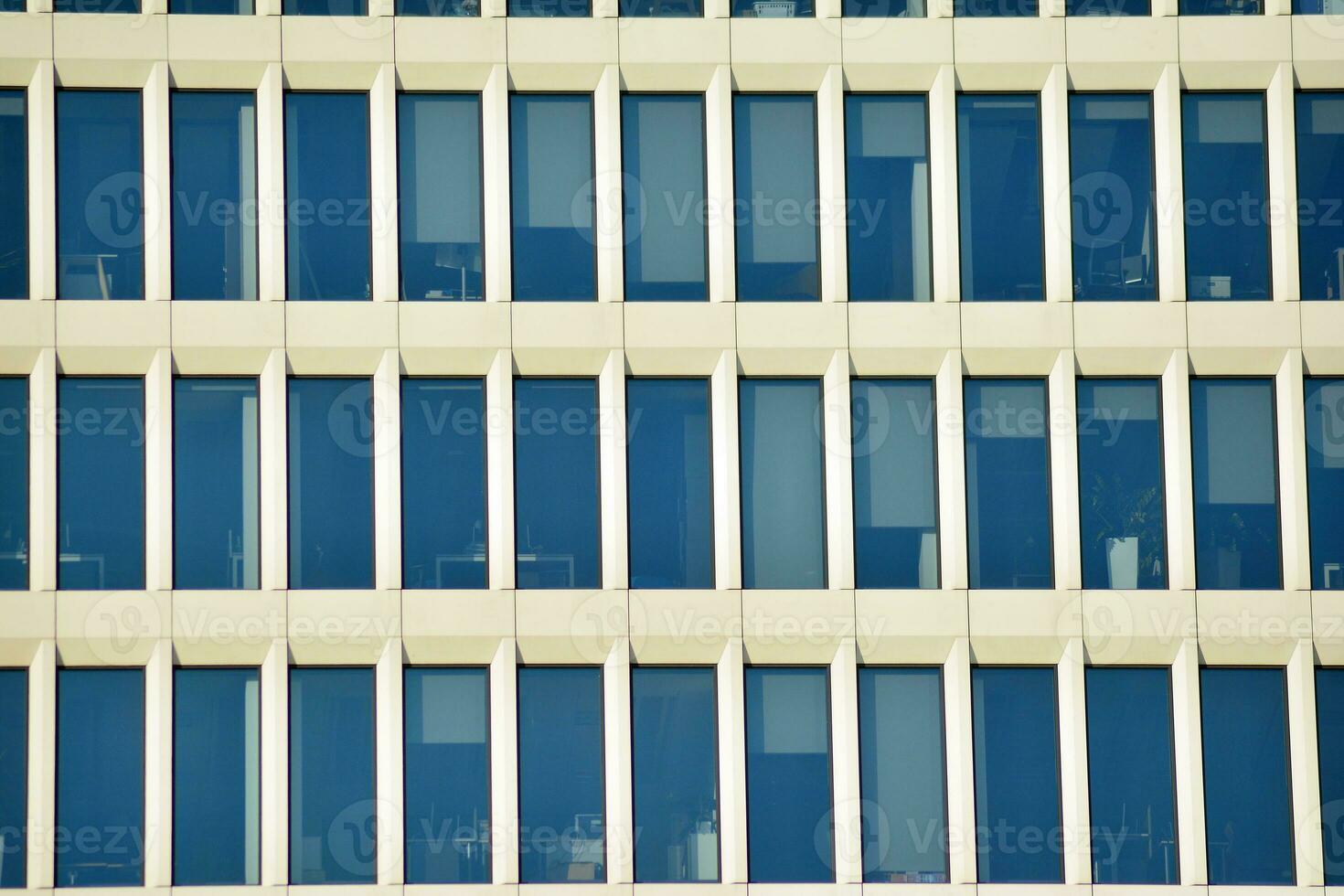 Glass building with transparent facade of the building and blue sky. Structural glass wall reflecting blue sky. Abstract modern architecture fragment. Contemporary architectural background. photo